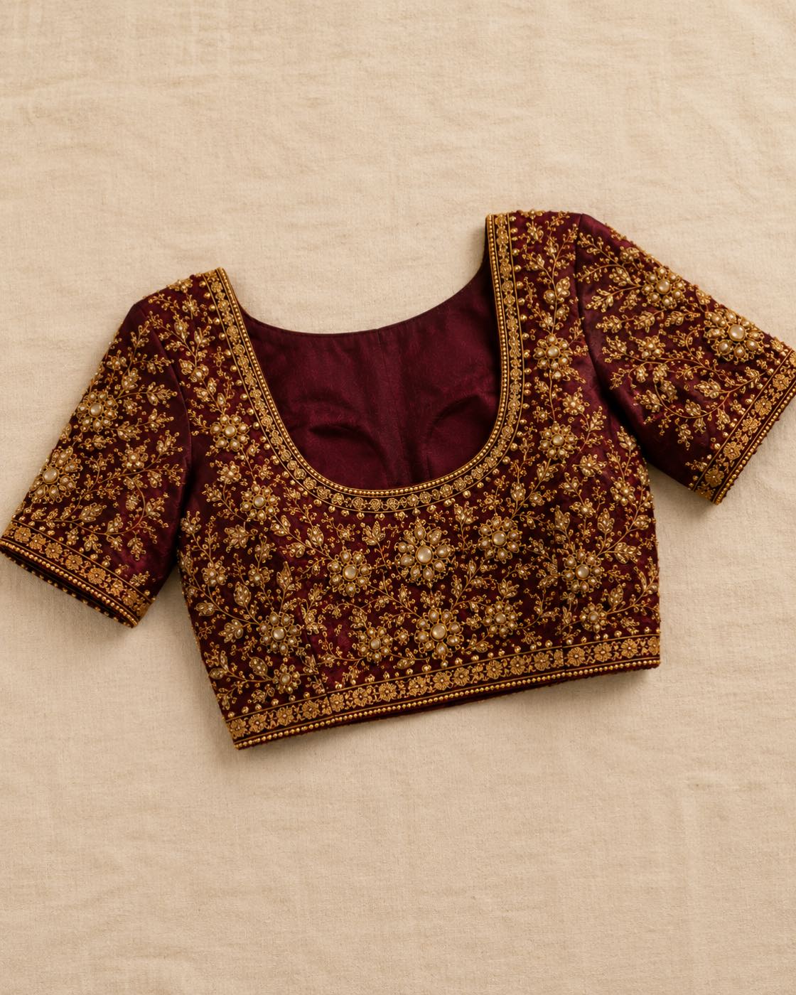 Wine silk blouse with dense antique-gold zardozi across the yoke and sleeves
