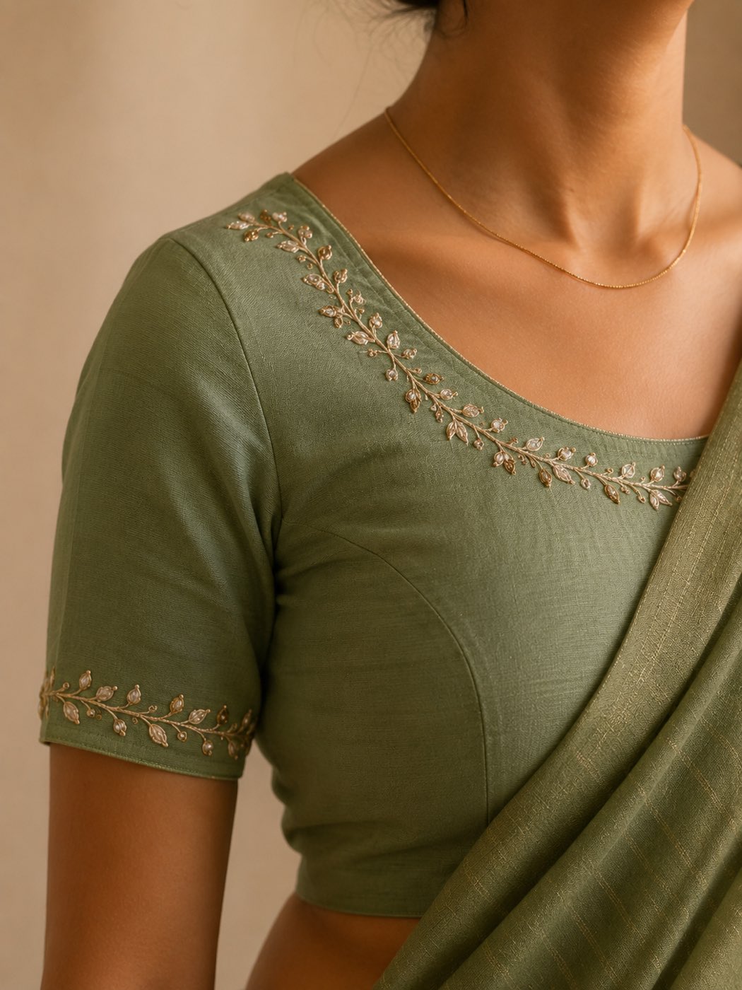 Sage-green blouse with a fine gold vine worked around the neckline and sleeve edge