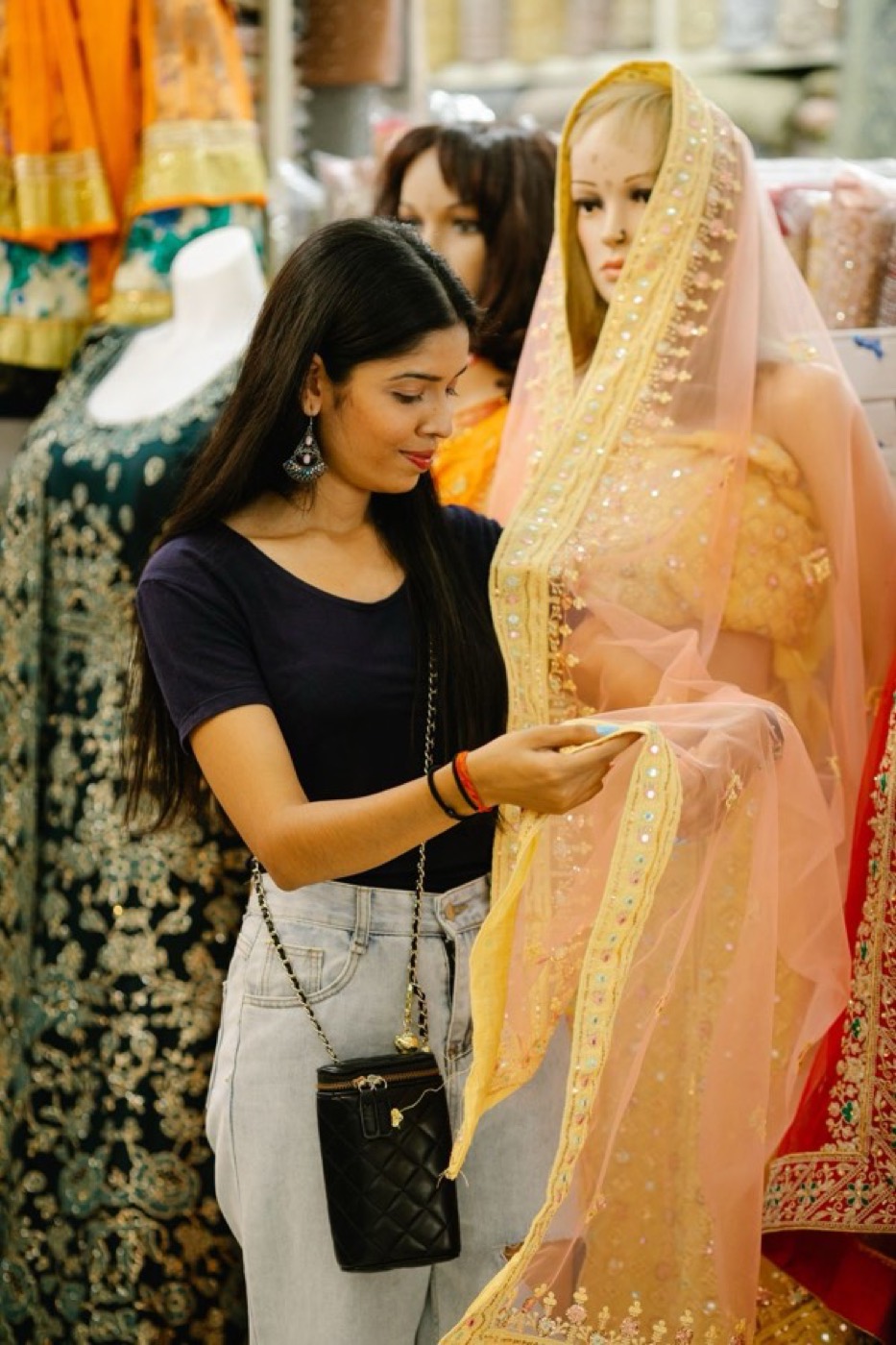 A customer looking through finished pieces in a bridal-wear studio